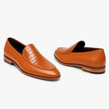 A pair of tan leather loafers, one showing the crocodile-embossed toe cap and the other showing the side profile, on a clean white background.